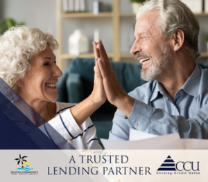 a older couple high fiving each other while holding documents